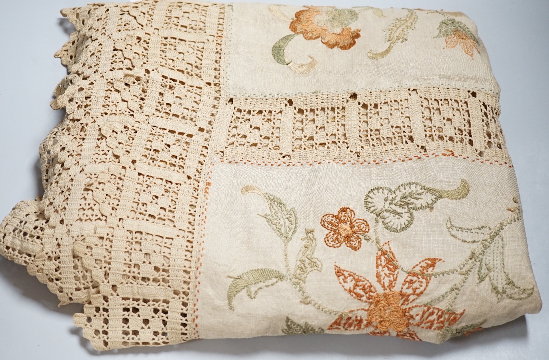 A 19th century Arts and Crafts bedcover; embroidered on linen in panels with crochet edges and borders